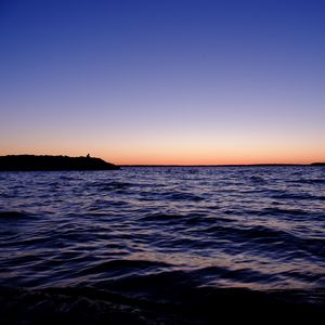 Preview wallpaper sea, sunset, loneliness, alone, silhouette, rocks