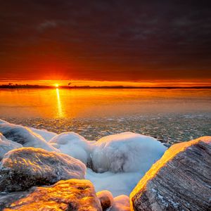 Preview wallpaper sea, sunset, shore, stones, ice