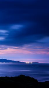 Preview wallpaper sea, sunset, skyline, mountains, city lights