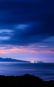 Preview wallpaper sea, sunset, skyline, mountains, city lights