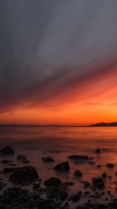 Preview wallpaper sea, sunset, stones, horizon, sky, coast