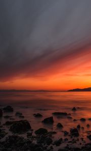 Preview wallpaper sea, sunset, stones, horizon, sky, coast