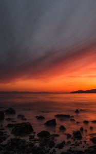 Preview wallpaper sea, sunset, stones, horizon, sky, coast