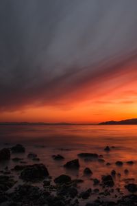 Preview wallpaper sea, sunset, stones, horizon, sky, coast