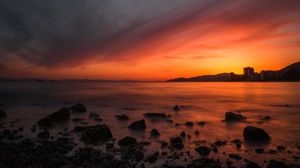 Preview wallpaper sea, sunset, stones, horizon, sky, coast