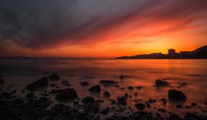 Preview wallpaper sea, sunset, stones, horizon, sky, coast