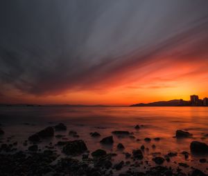 Preview wallpaper sea, sunset, stones, horizon, sky, coast