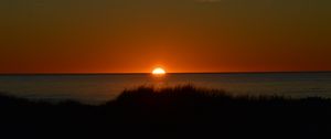 Preview wallpaper sea, sunset, sun, water, dusk, evening