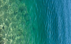 Preview wallpaper sea, water, bottom, stones, glare, nature