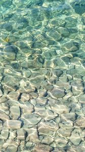 Preview wallpaper sea, water, bottom, stones, pebbles, glare