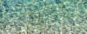Preview wallpaper sea, water, bottom, stones, pebbles, glare