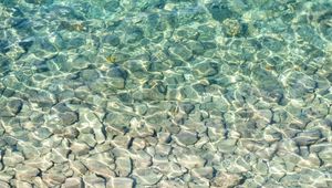Preview wallpaper sea, water, bottom, stones, pebbles, glare