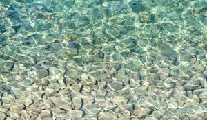 Preview wallpaper sea, water, bottom, stones, pebbles, glare