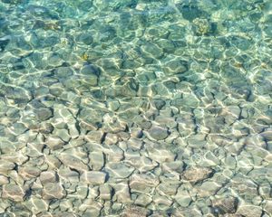 Preview wallpaper sea, water, bottom, stones, pebbles, glare