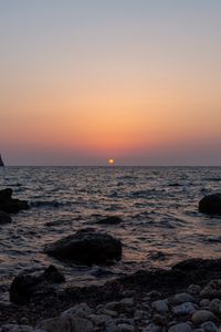 Preview wallpaper sea, water, stones, sun, sunset