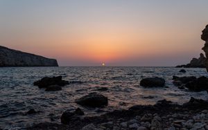 Preview wallpaper sea, water, stones, sun, sunset
