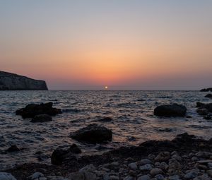 Preview wallpaper sea, water, stones, sun, sunset