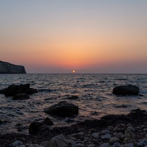 Preview wallpaper sea, water, stones, sun, sunset
