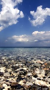 Preview wallpaper sea, water, transparent, stones, bottom, clouds, sky