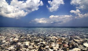 Preview wallpaper sea, water, transparent, stones, bottom, clouds, sky