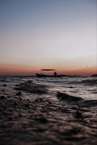 Preview wallpaper sea, waves, boat, silhouette, dark, dusk