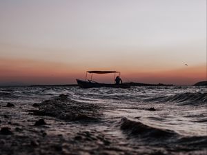 Preview wallpaper sea, waves, boat, silhouette, dark, dusk