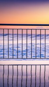 Preview wallpaper sea, waves, fence, stripes, reflection, twilight