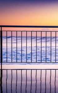 Preview wallpaper sea, waves, fence, stripes, reflection, twilight