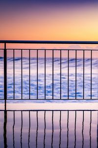 Preview wallpaper sea, waves, fence, stripes, reflection, twilight