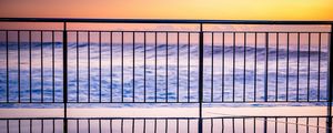 Preview wallpaper sea, waves, fence, stripes, reflection, twilight