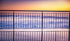 Preview wallpaper sea, waves, fence, stripes, reflection, twilight