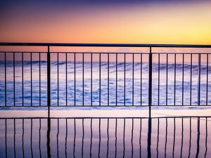 Preview wallpaper sea, waves, fence, stripes, reflection, twilight
