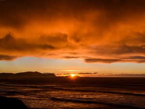 Preview wallpaper sea, waves, hills, sunset, clouds