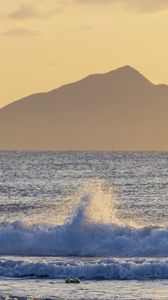Preview wallpaper sea, waves, splashes, mountain, silhouette, landscape