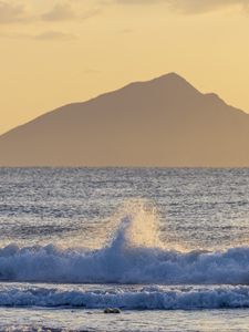 Preview wallpaper sea, waves, splashes, mountain, silhouette, landscape