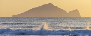 Preview wallpaper sea, waves, splashes, mountain, silhouette, landscape