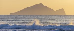 Preview wallpaper sea, waves, splashes, mountain, silhouette, landscape