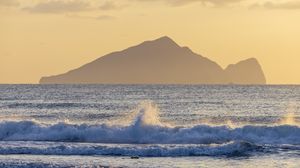Preview wallpaper sea, waves, splashes, mountain, silhouette, landscape