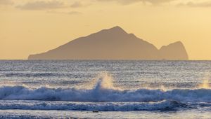 Preview wallpaper sea, waves, splashes, mountain, silhouette, landscape