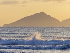 Preview wallpaper sea, waves, splashes, mountain, silhouette, landscape