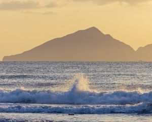 Preview wallpaper sea, waves, splashes, mountain, silhouette, landscape