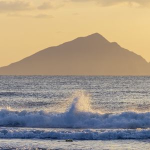 Preview wallpaper sea, waves, splashes, mountain, silhouette, landscape