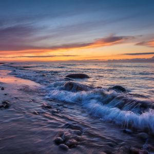 Preview wallpaper sea, waves, stones, sunset