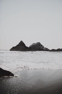 Preview wallpaper sea, waves, surfer, rocks, beach