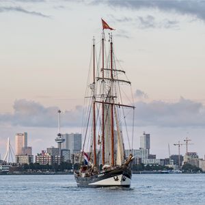 Preview wallpaper ship, city, sea, sky, clouds