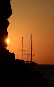 Preview wallpaper ship, masts, rock, evening