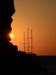 Preview wallpaper ship, masts, rock, evening