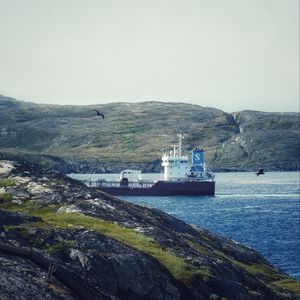 Preview wallpaper ship, sea, coast, hills, rocks