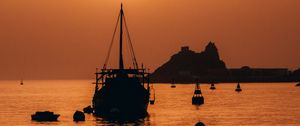 Preview wallpaper ship, sunset, glare, silhouette, sea