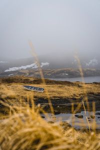Preview wallpaper shore, boat, fog, lake, hills